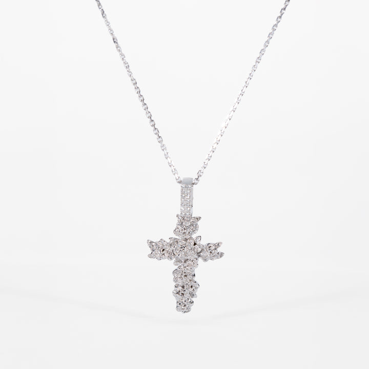 white gold cross pendant necklace on a white background