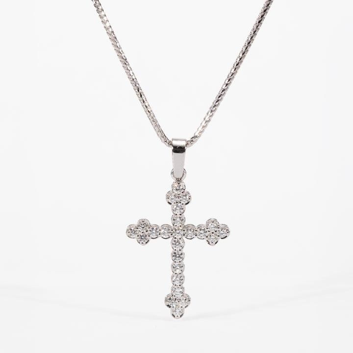 Silver cross pendant necklace on a white background