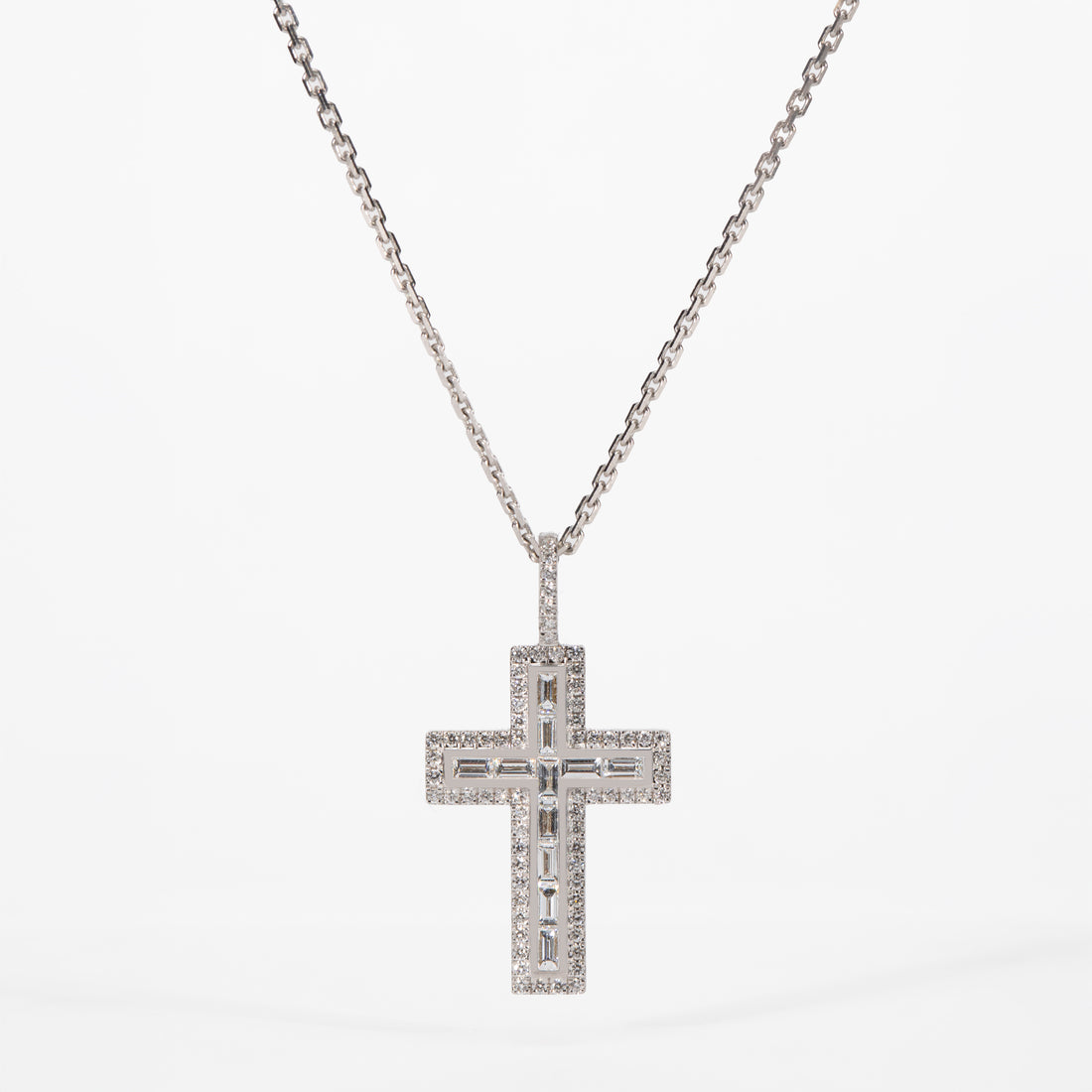 Diamond cross pendant necklace on a white background