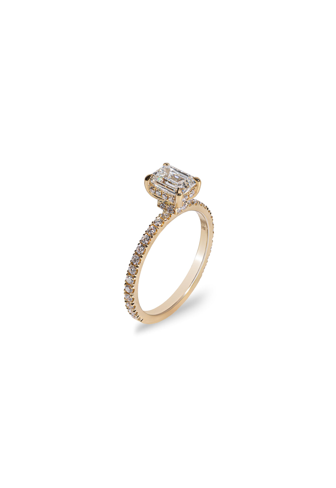 Angled view of the Aurelle emerald-cut diamond engagement ring in 18K yellow gold, showing the diamond-set band and raised setting.